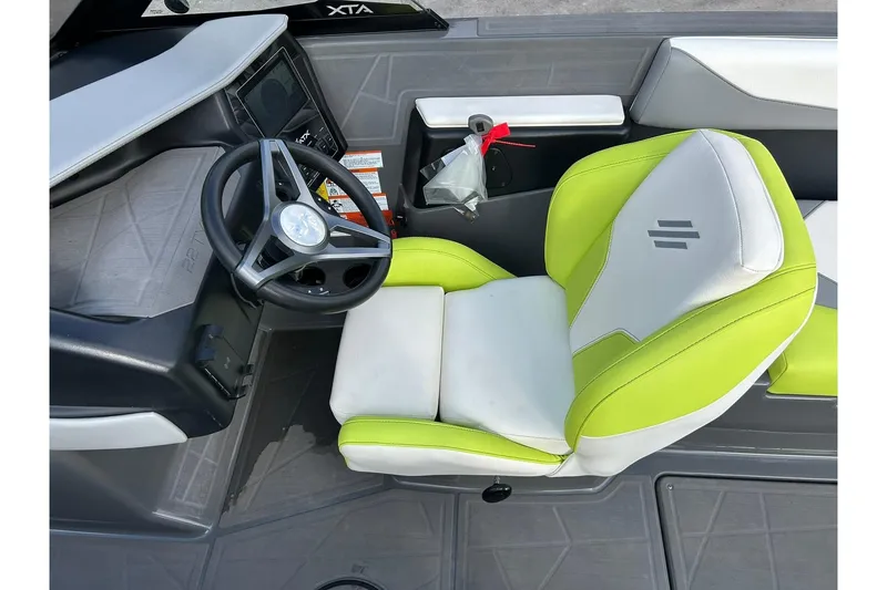 Slide: The Image of ATX 22 Type-S 2021 boat interior with lime green and white seating, steering wheel, and dashboard. - 41