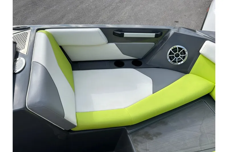 Slide: The Image of 2021 ATX 22 Type-S boat interior with lime green and gray seating, speaker, and cup holders. - 49