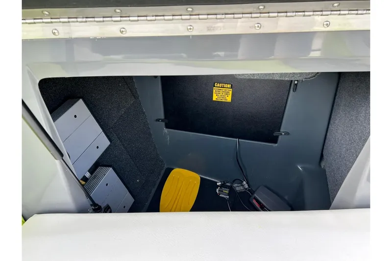 Slide: The Image of 2021 ATX 22 Type-S storage compartment with electronic components and caution label. - 56