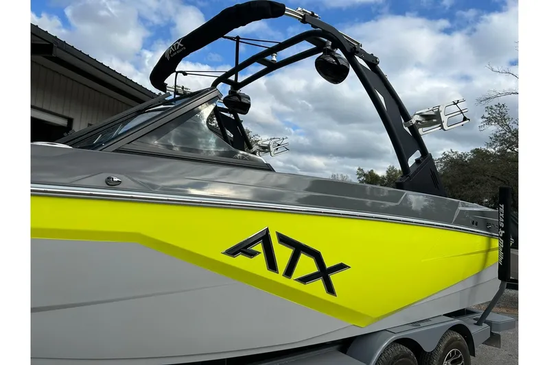 Slide: The Image of 2021 ATX 22 Type-S boat with vibrant yellow and gray design, parked outdoors. - 58