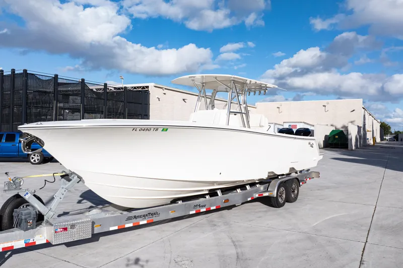 Slide: The Image of 2021 SeaVee 322Z boat on trailer, parked outdoors under a blue sky. - 11