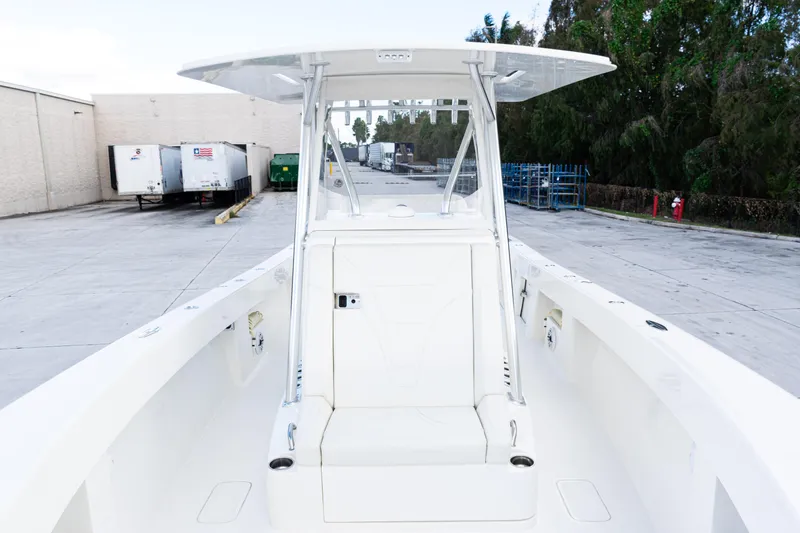 Slide: The Image of 2021 SeaVee 322Z boat with center console, docked in an industrial area. - 21
