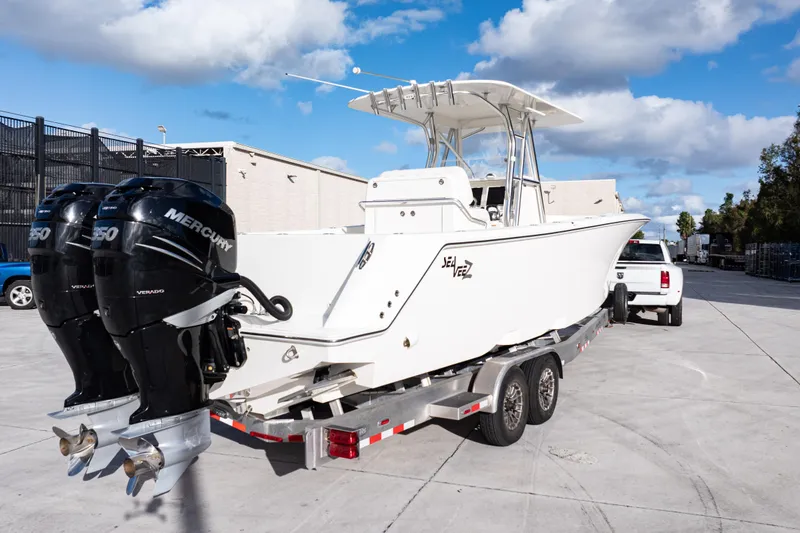 Slide: The Image of 2021 SeaVee 322Z boat on trailer with dual Mercury engines, parked outdoors. - 3