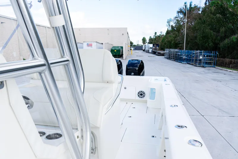Slide: The Image of 2021 SeaVee 322Z boat with dual engines, docked in an industrial area. - 32