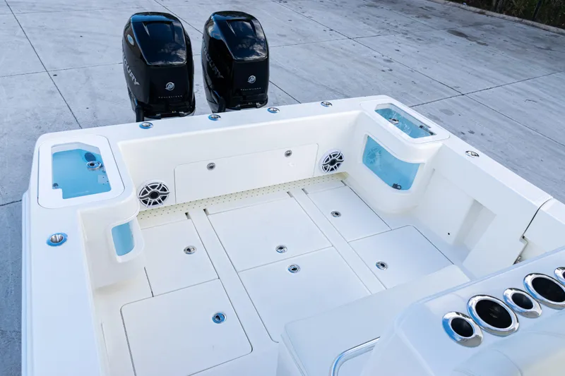 Slide: The Image of 2021 SeaVee 322Z boat deck with dual Mercury engines and storage compartments. - 37