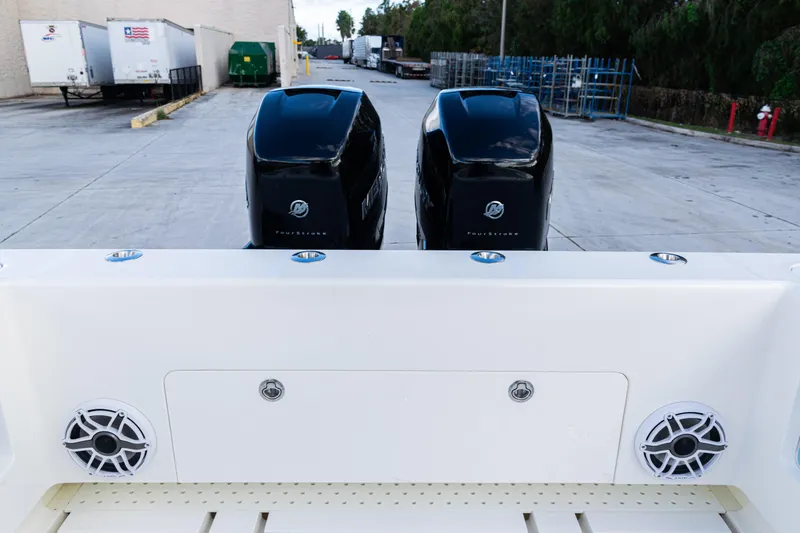 Slide: The Image of 2021 SeaVee 322Z boat with dual Mercury FourStroke engines, docked in an industrial area. - 38