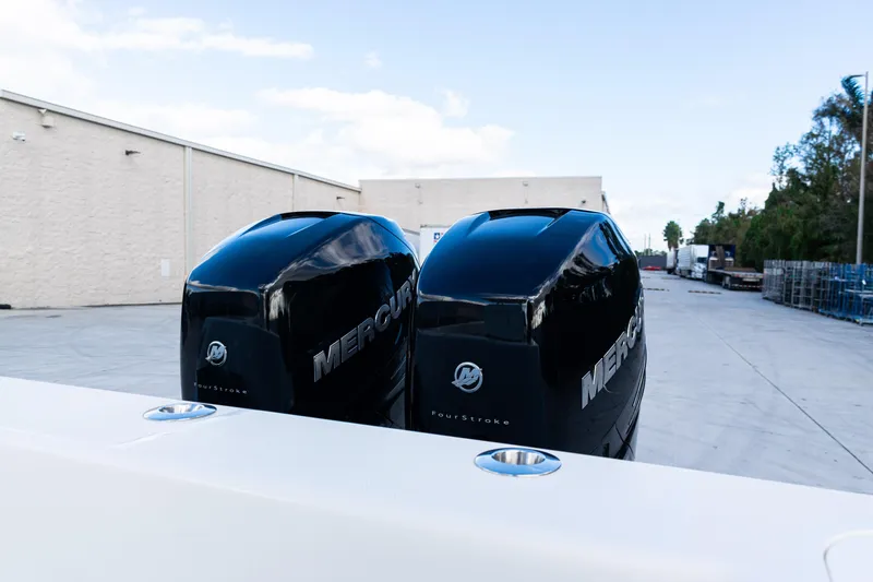 Slide: The Image of Twin Mercury outboard engines on a 2021 SeaVee 322Z boat, parked outdoors. - 40