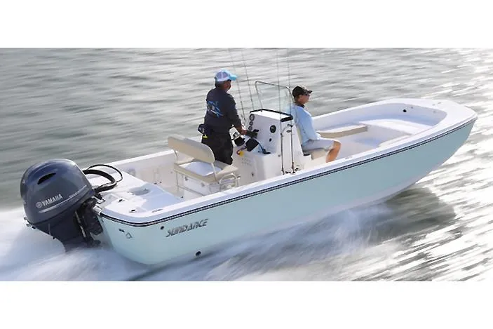 The Image of 2026 Sundance DX22 boat speeding on calm water with two passengers. - 0