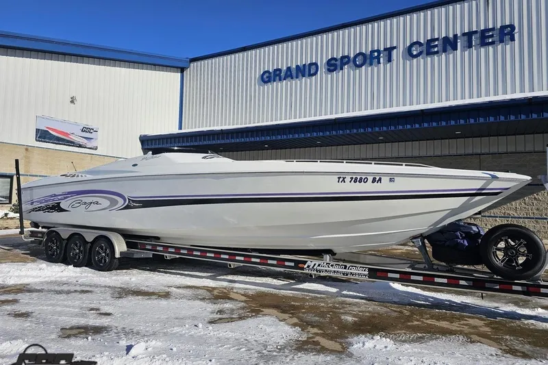 Slide: The Image of 2001 Baja 36 Outlaw boat on trailer at Grand Sport Center in snowy setting. - 12