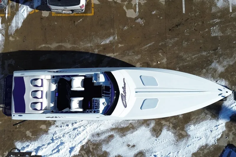 Slide: The Image of Aerial view of 2001 Baja 36 Outlaw boat parked on snowy pavement. - 15