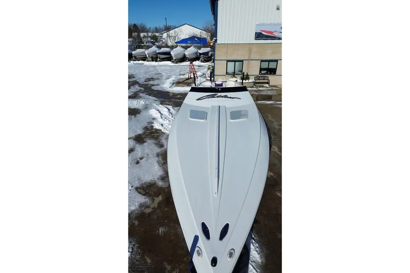 Slide: The Image of 2001 Baja 36 Outlaw boat in snowy outdoor setting near a building. - 17