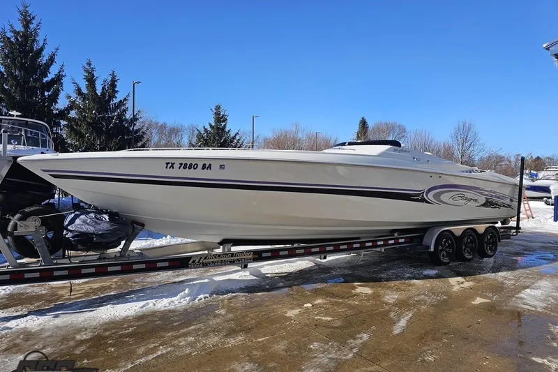 Slide: The Image of 2001 Baja 36 Outlaw speedboat on trailer, parked outdoors on a sunny day. - 18