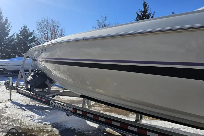 Slide: The Image of 2001 Baja 36 Outlaw boat on trailer, parked in snowy outdoor setting. - 22