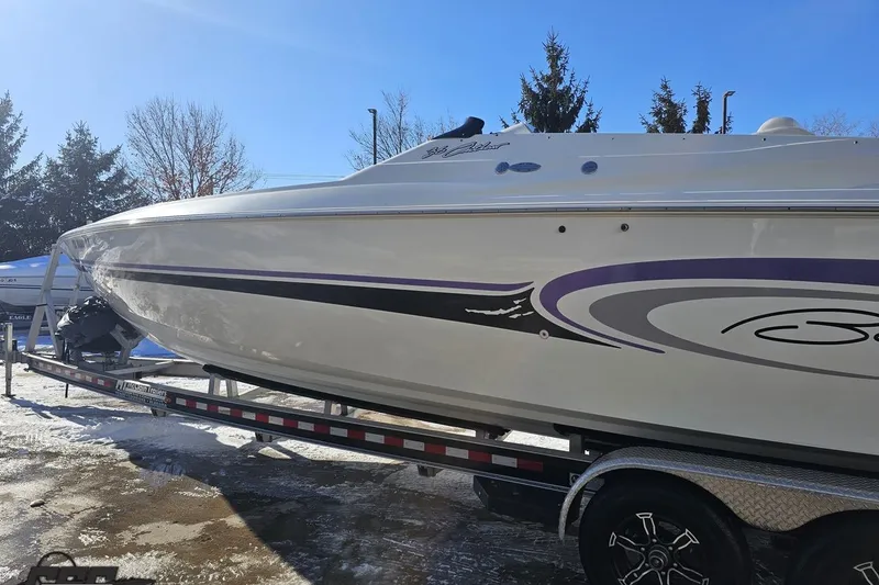 Slide: The Image of 2001 Baja 36 Outlaw boat on trailer, featuring sleek design and purple accents. - 23