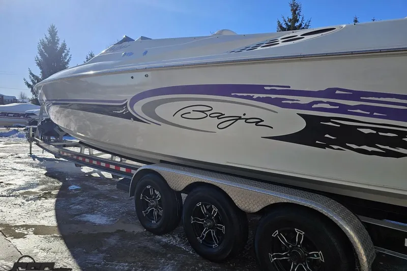 Slide: The Image of 2001 Baja 36 Outlaw boat on trailer, featuring sleek design and vibrant graphics. - 24