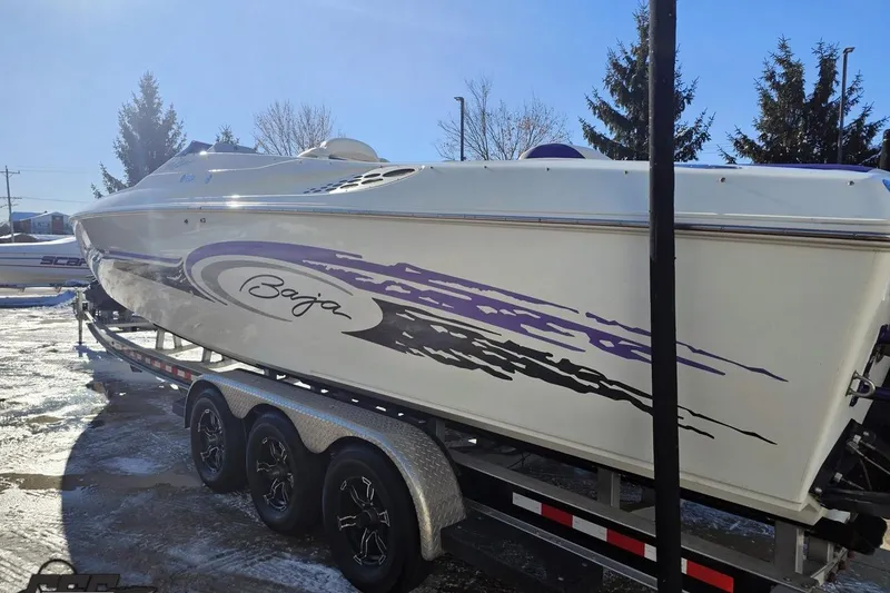 Slide: The Image of 2001 Baja 36 Outlaw speedboat on trailer, featuring sleek design and vibrant graphics. - 25