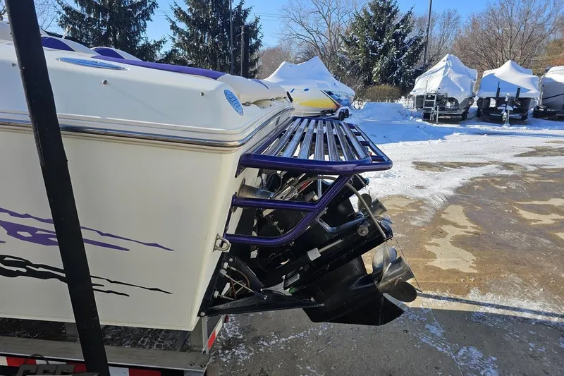 Slide: The Image of 2001 Baja 36 Outlaw boat rear view with propeller, parked in snowy marina. - 26