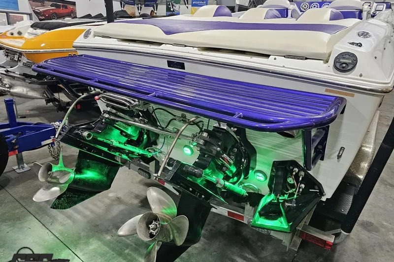 Slide: The Image of 2001 Baja 36 Outlaw boat with illuminated green underwater lights and dual propellers. - 31