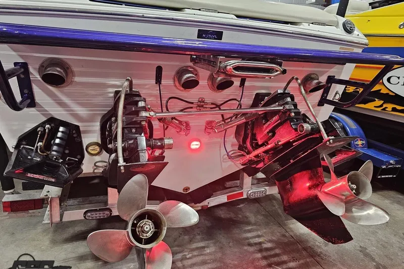 Slide: The Image of Rear view of a 2001 Baja 36 Outlaw boat with dual propellers and red lighting. - 33