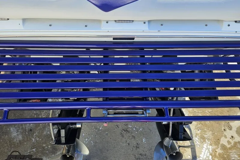 Slide: The Image of Rear view of a 2001 Baja 36 Outlaw boat with blue metal bars. - 34