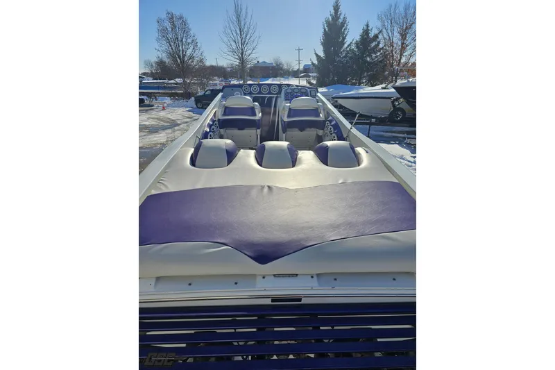 Slide: The Image of 2001 Baja 36 Outlaw boat interior with purple and white seating, parked in snowy area. - 36