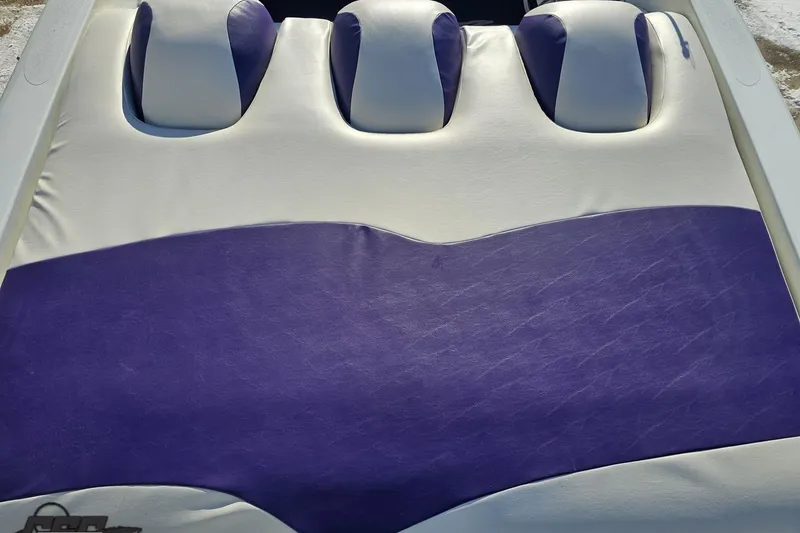 Slide: The Image of 2001 Baja 36 Outlaw boat seat with white and purple upholstery. - 37
