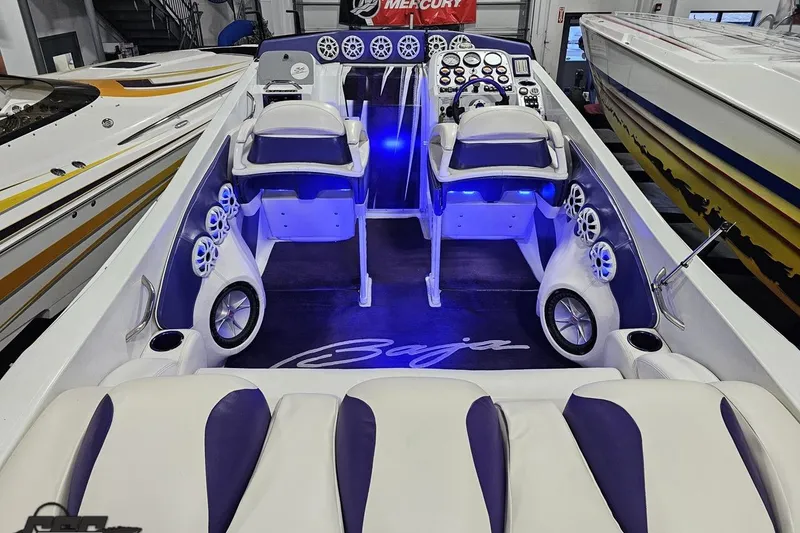 Slide: The Image of 2001 Baja 36 Outlaw boat interior with blue lighting and modern dashboard. - 39