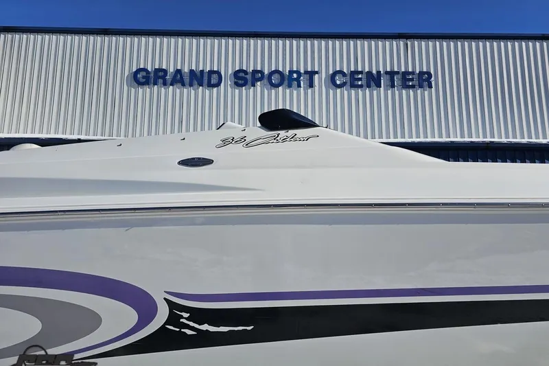Slide: The Image of 2001 Baja 36 Outlaw boat at Grand Sport Center, featuring sleek design and graphics. - 4