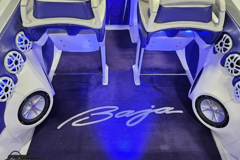 Slide: The Image of Interior of 2001 Baja 36 Outlaw boat with blue lighting and custom speakers. - 43