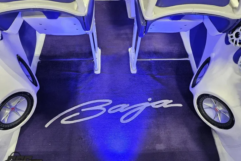 Slide: The Image of Interior of 2001 Baja 36 Outlaw boat with blue lighting and logo. - 44