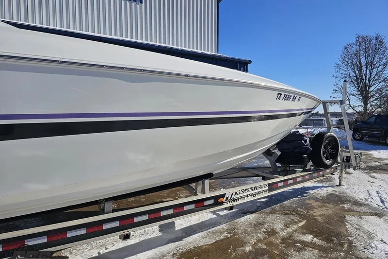 Slide: The Image of 2001 Baja 36 Outlaw boat on trailer, parked outdoors in snowy setting. - 5