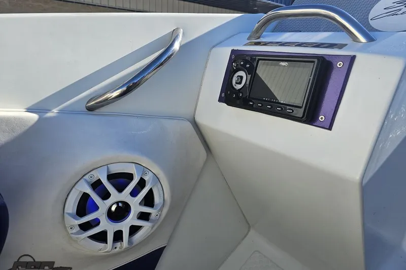Slide: The Image of 2001 Baja 36 Outlaw boat interior with audio system and speaker. - 51