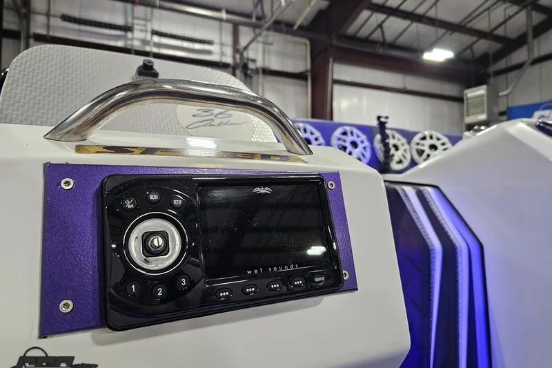 Slide: The Image of 2001 Baja 36 Outlaw boat dashboard with audio system and sleek design. - 52