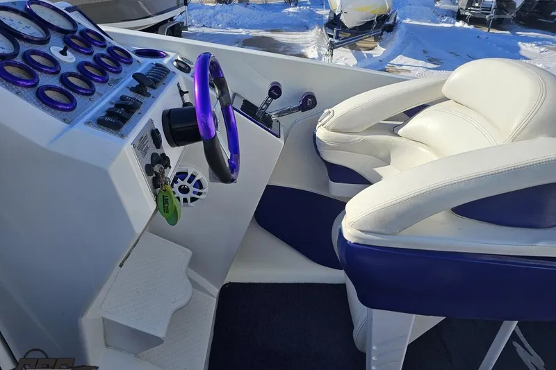 Slide: The Image of 2001 Baja 36 Outlaw boat cockpit with purple accents and white seating. - 54