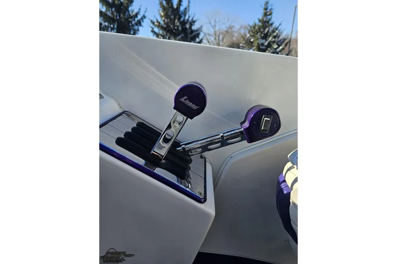 Slide: The Image of Throttle controls of a 2001 Baja 36 Outlaw boat with purple accents. - 56