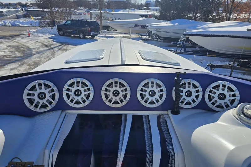 Slide: The Image of 2001 Baja 36 Outlaw boat with six speakers on deck, parked in snowy marina. - 59