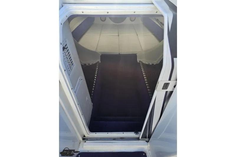 Slide: The Image of 2001 Baja 36 Outlaw cabin interior with white and blue accents. - 61