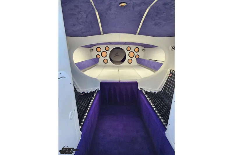 Slide: The Image of Interior of 2001 Baja 36 Outlaw boat with purple and white upholstery. - 62