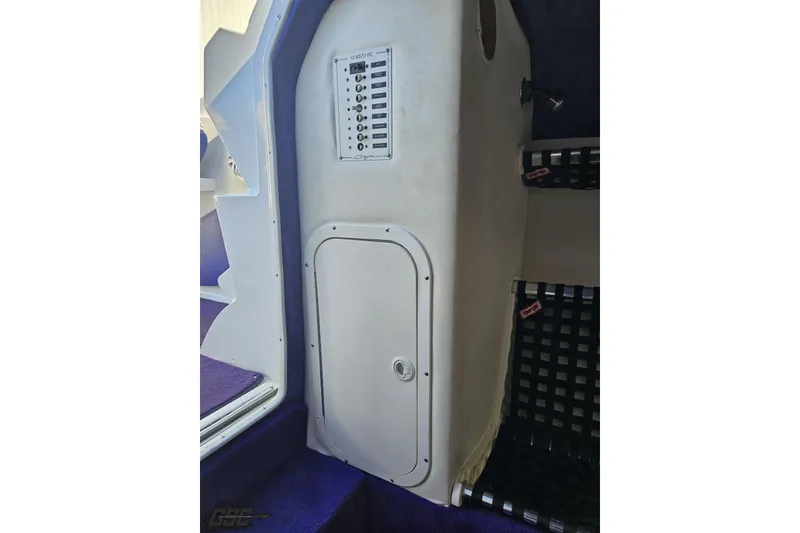 Slide: The Image of Interior view of a 2001 Baja 36 Outlaw boat, featuring a control panel and storage compartment. - 67