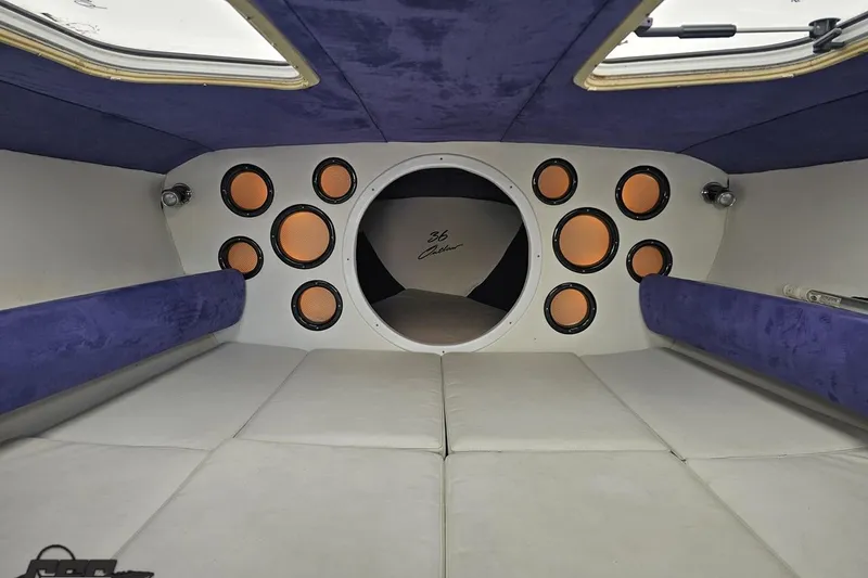 Slide: The Image of Interior of 2001 Baja 36 Outlaw boat with plush seating and multiple speakers. - 69