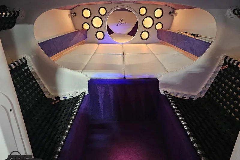 Slide: The Image of Interior of a 2001 Baja 36 Outlaw boat with purple and white seating. - 71