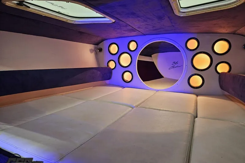 Slide: The Image of Interior of 2001 Baja 36 Outlaw boat with modern lighting and cushioned seating. - 73