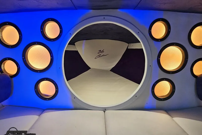 Slide: The Image of Interior of 2001 Baja 36 Outlaw boat with illuminated speakers and modern design. - 74