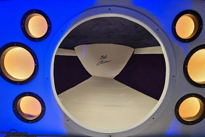 Slide: The Image of Interior of 2001 Baja 36 Outlaw boat with illuminated speakers and sleek design. - 75