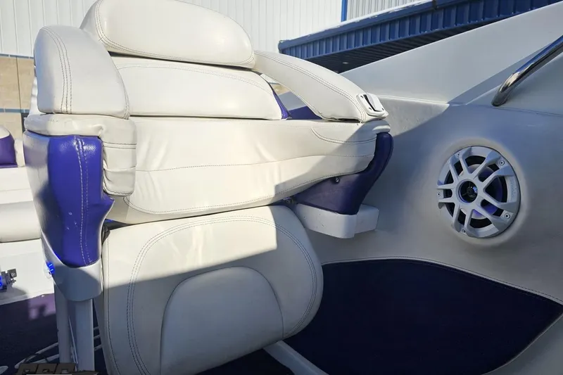 Slide: The Image of White and blue seating in a 2001 Baja 36 Outlaw boat interior. - 78