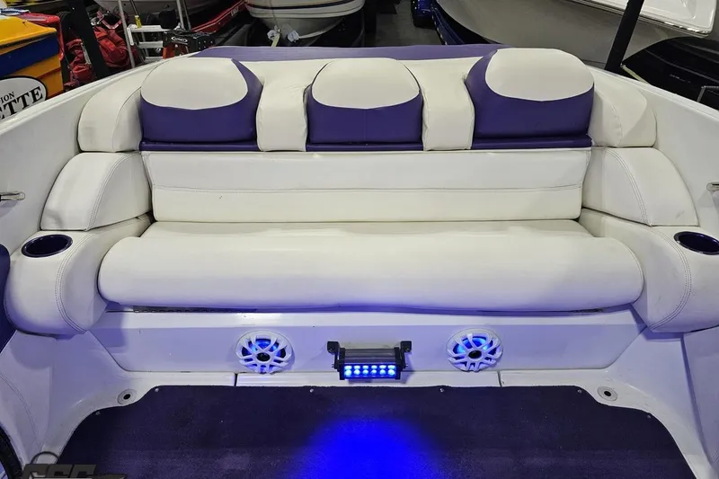 Slide: The Image of 2001 Baja 36 Outlaw boat interior with white and purple seating, blue LED lights. - 81