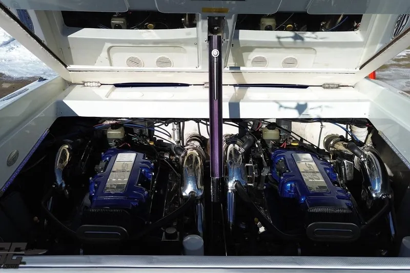 Slide: The Image of 2001 Baja 36 Outlaw boat engine compartment with dual blue engines. - 86