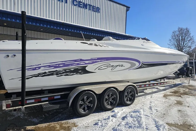 Slide: The Image of 2001 Baja 36 Outlaw speedboat on trailer, featuring sleek design and vibrant graphics. - 9