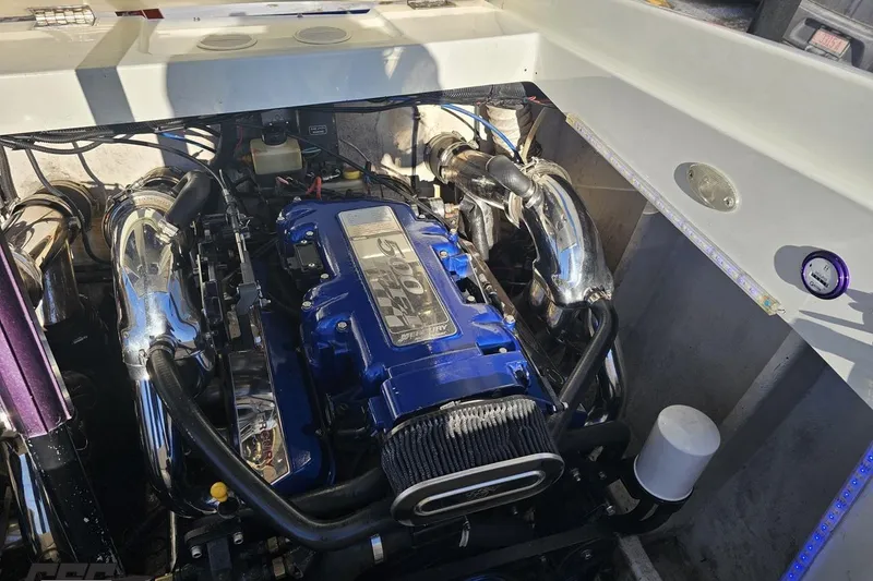 Slide: The Image of Engine compartment of a 2001 Baja 36 Outlaw boat with a powerful engine. - 92