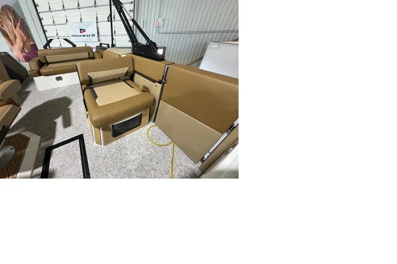 Slide: The Image of 2026 Revel RS25 interior with tan seating and modern design in a showroom. - 2